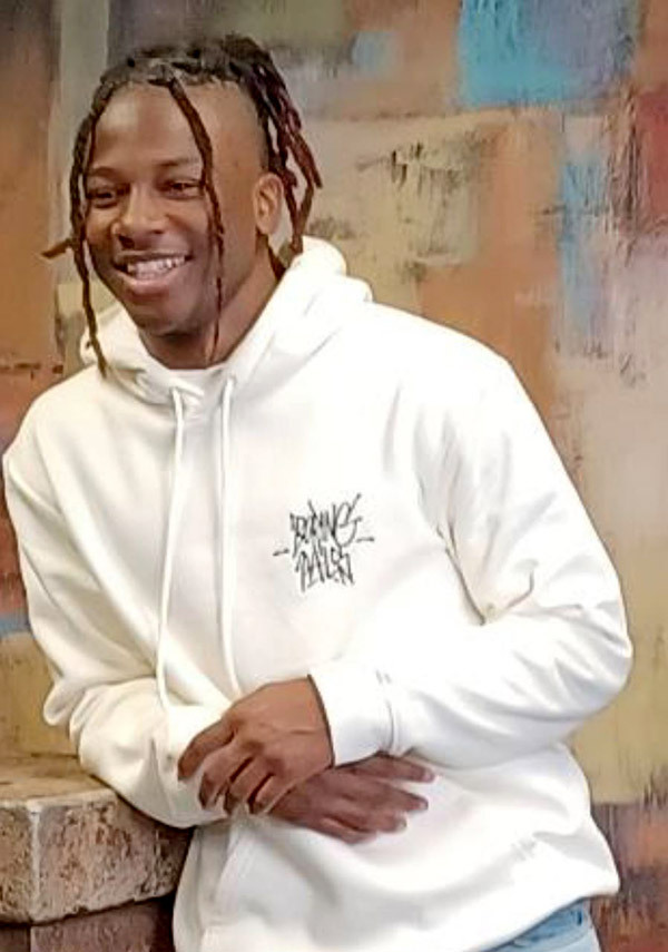 JaShawn Harris leaning with elbow on half wall smiling